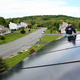 Workers install panels on the roof of a home in Newburgh, New York.